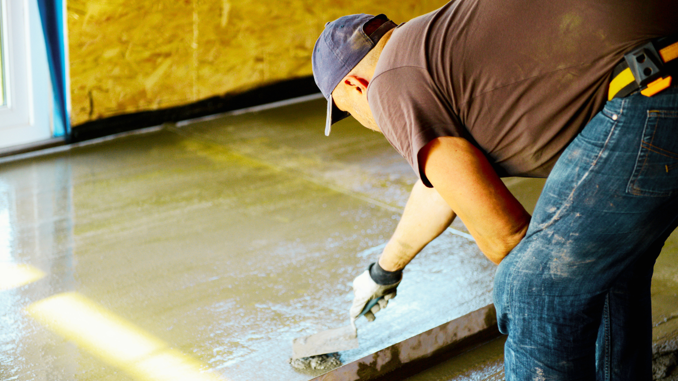 Why Indoor Concrete Repair is Essential for Long-Lasting Floors A worker smooths a freshly poured concrete floor, highlighting the importance of indoor concrete repair for durability and longevity.